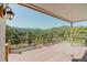 A wooden deck with wood railings offering panoramic views of the surrounding mountain landscape at 12135 Cochise Cir, Conifer, CO 80433