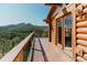 Exterior deck showcasing log siding and mountain views at 12135 Cochise Cir, Conifer, CO 80433