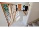 Inviting home foyer featuring stone tile flooring, a wood-burning stove, and stairway access at 12135 Cochise Cir, Conifer, CO 80433