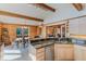 Open kitchen featuring wood beams, log walls, granite counters, and a breakfast nook with amazing views at 12135 Cochise Cir, Conifer, CO 80433