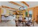 Eat in kitchen with wooden beams, bar seating, dining area and views of the mountain at 12135 Cochise Cir, Conifer, CO 80433
