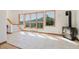A bright living room with large windows, and tile floors, showcasing stunning views at 12135 Cochise Cir, Conifer, CO 80433