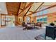 Spacious living area with log walls, high ceilings, and large windows with scenic views at 12135 Cochise Cir, Conifer, CO 80433