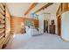 Bright, well-lit main bedroom with log walls, plush carpet, and natural light at 12135 Cochise Cir, Conifer, CO 80433