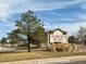 Sign for Aurora Plaza with trees in front at 755 Newark St, Aurora, CO 80010