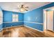 Bright bedroom with hardwood floors, a ceiling fan, and a window at 755 Newark St, Aurora, CO 80010