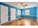 Bedroom featuring hardwood floors, ceiling fan, updated baseboards and a door leading outside at 755 Newark St, Aurora, CO 80010