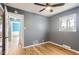A comfortable bedroom with hardwood floors, a window providing natural light and neutral paint at 755 Newark St, Aurora, CO 80010