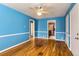 Open bedroom with hardwood floors, ceiling fan and multiple entry points at 755 Newark St, Aurora, CO 80010