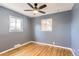 This bedroom has hardwood floors, a ceiling fan, natural light, and neutral paint at 755 Newark St, Aurora, CO 80010