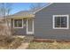 Front entry view of single story home showcasing the front door and updated facade at 755 Newark St, Aurora, CO 80010