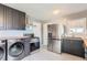 Open kitchen with stainless steel appliances and new front loading washer and dryer at 755 Newark St, Aurora, CO 80010
