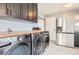 This kitchen features gray cabinets, wooden countertops, white backsplash, and stainless steel appliances at 755 Newark St, Aurora, CO 80010