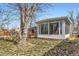 Enclosed sunroom extends from the home with tons of light from surrounding windows at 755 Newark St, Aurora, CO 80010