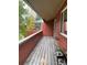 Outdoor balcony with wood flooring, a wooden railing, and plants overlooking a canopy of trees at 1415 Bacchus Dr # D9, Lafayette, CO 80026