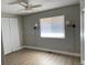 Bedroom with a ceiling fan, window with blinds, sconce lighting, and a closet with folding doors at 1415 Bacchus Dr # D9, Lafayette, CO 80026