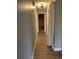 Hallway with neutral wall paint and vinyl floors leading to a bedroom with carpet at 1415 Bacchus Dr # D9, Lafayette, CO 80026