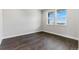 Neutral bedroom showcasing hardwood floors, white trim, and large windows at 3983 Breakcamp Ct, Castle Rock, CO 80108