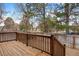 Wooden deck overlooking the fenced backyard with mature trees at 4028 S Atchison Way, Aurora, CO 80014