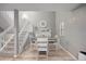 Bright dining room with hardwood floors, adjacent staircase, and decorative fireplace and mantle at 4028 S Atchison Way, Aurora, CO 80014