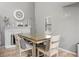 Bright dining room features modern glass table, decorative fireplace, and neutral paint at 4028 S Atchison Way, Aurora, CO 80014