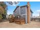 Charming home featuring a classic brick chimney and a spacious backyard with a wooden deck at 4028 S Atchison Way, Aurora, CO 80014