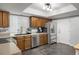 Well-lit kitchen with stainless steel appliances, wood cabinets, and tile floor at 4028 S Atchison Way, Aurora, CO 80014