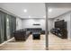 Spacious living room featuring wood floors, neutral paint, recessed lighting, and large sectional sofa at 4028 S Atchison Way, Aurora, CO 80014