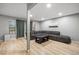 Spacious living room with wood floors, gray sofa and access to the backyard deck at 4028 S Atchison Way, Aurora, CO 80014
