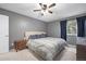 Comfortable main bedroom featuring ceiling fan, closet, and natural light from window at 4028 S Atchison Way, Aurora, CO 80014