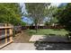 Large fenced backyard with mature trees and partial patio at 11524 Marshall Ct, Broomfield, CO 80020