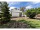 Large fenced backyard featuring green grass, mature trees, and a partial patio area at 11524 Marshall Ct, Broomfield, CO 80020
