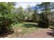 Fenced backyard featuring mature trees and green grass at 11524 Marshall Ct, Broomfield, CO 80020