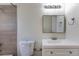 A close up of a bathroom featuring a toilet, sink, vanity, mirror, and lighting at 11524 Marshall Ct, Broomfield, CO 80020