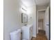 A bathroom featuring a toilet, vanity, sink, mirror, and access to the upstairs of the home at 11524 Marshall Ct, Broomfield, CO 80020