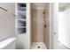 Bathroom features a shower, toilet, tiled wall, towel rack, and shelves at 11524 Marshall Ct, Broomfield, CO 80020