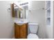 Bathroom featuring a sink, toilet, mirror, vanity, and towel rack at 11524 Marshall Ct, Broomfield, CO 80020