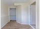 Bright bedroom featuring neutral walls, carpet, closet, and open door at 11524 Marshall Ct, Broomfield, CO 80020
