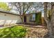 Charming home featuring stone accents, a well-manicured lawn, and a welcoming entrance with lush greenery at 11524 Marshall Ct, Broomfield, CO 80020