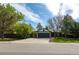 Exterior view of single Gathering home with stone detail, a two car garage, and mature trees at 11524 Marshall Ct, Broomfield, CO 80020
