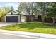 Beautiful single-Gathering home with a lush green lawn, stone accents, a two-car garage, and mature trees at 11524 Marshall Ct, Broomfield, CO 80020