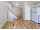 Modern kitchen with wood flooring, stairs to second floor, and a refrigerator by pantry at 11524 Marshall Ct, Broomfield, CO 80020