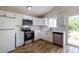 Well-lit kitchen featuring white cabinets, stainless steel appliances, and stylish flooring for a contemporary design at 11524 Marshall Ct, Broomfield, CO 80020