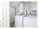 Bright laundry room features a modern washer and dryer with upper cabinets at 11524 Marshall Ct, Broomfield, CO 80020