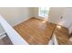 Open living room with hardwood floors, a large window, and access to the stairs and front door at 11524 Marshall Ct, Broomfield, CO 80020