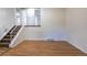 Spacious living room with hardwood floors, staircase, and neutral paint, providing a versatile living space at 11524 Marshall Ct, Broomfield, CO 80020