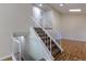 Carpeted staircase with white railing leading to the upper level, creating an inviting transition at 11524 Marshall Ct, Broomfield, CO 80020