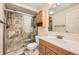 Bathroom features a step-in shower with glass door and neutral stone tiling at 624 4Th St, Frederick, CO 80530