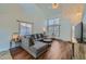 Bright living room with wood floors, neutral walls, a high ceiling and multiple windows with views of the outdoors at 624 4Th St, Frederick, CO 80530