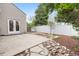 Spacious backyard with concrete patio, white fence, and rock and mulch landscaping at 2275 S Yosemite Cir, Denver, CO 80231